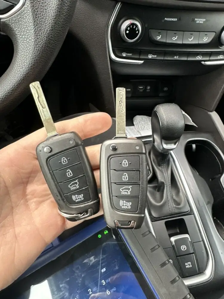 Car key fobs with embedded physical keys for vehicle access.