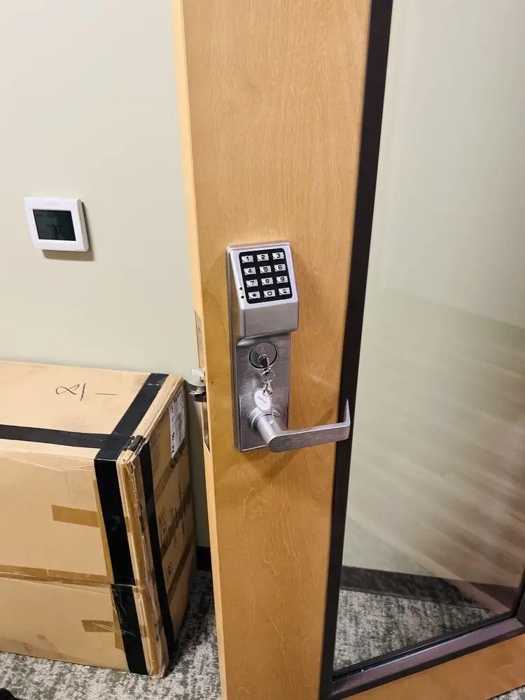 Keypad lock system with traditional key entry on an office door.