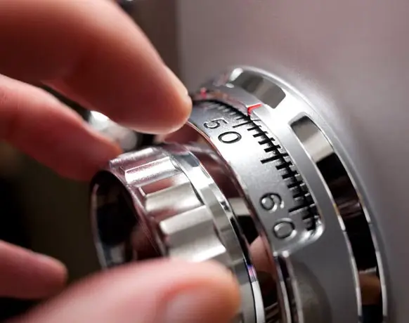 Auburn Safe & Lock technician performing combination change or lock maintenance on a high-security safe dial.